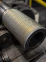 Close-up of welded hardfacing overlay on sleeve-type pump component